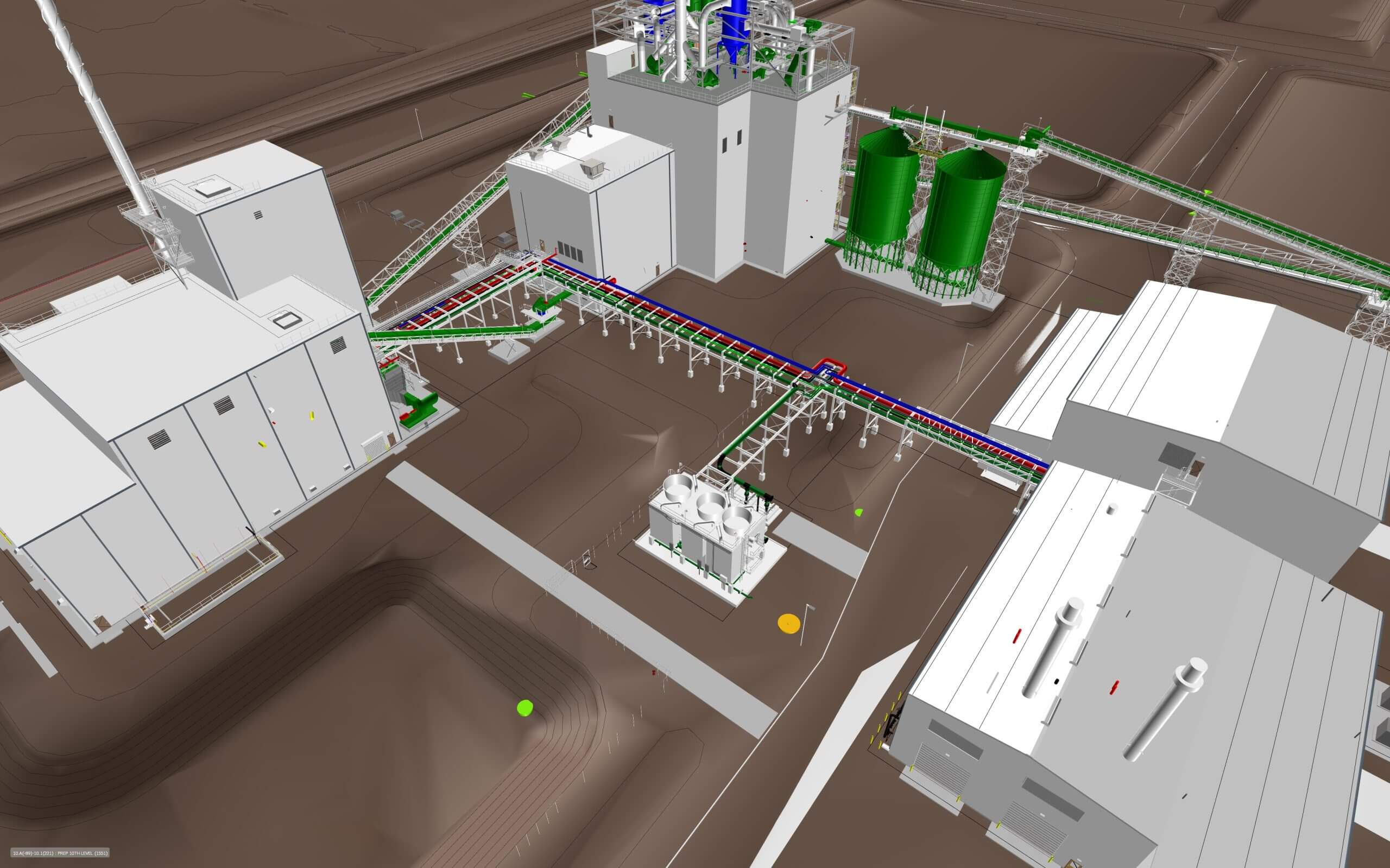 Aerial view of an industrial facility layout, featuring multiple large white buildings connected by a network of colored pipelines and conveyors, with green storage tanks visible on the right.